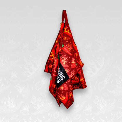 A hanging flaming chilli pepper patterned microfibre golf towel