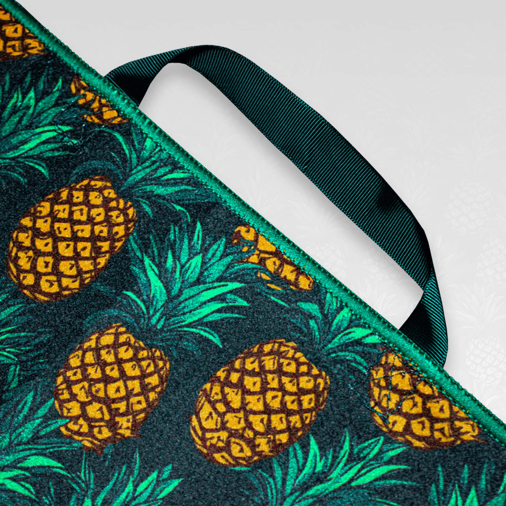 A close up of the handle of a pineapple patterned microfibre golf towel