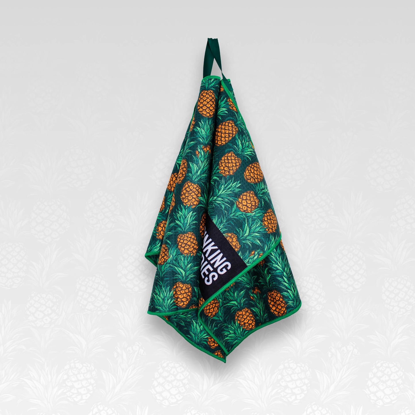 A hanging pineapple patterned microfibre golf towel
