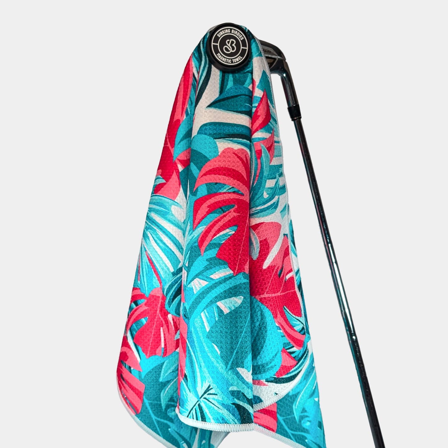 Magnetic golf towel hanging from golf club