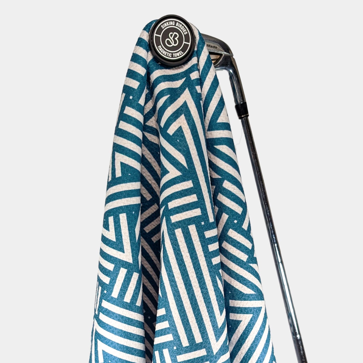 Magnetic golf towel hanging from golf club