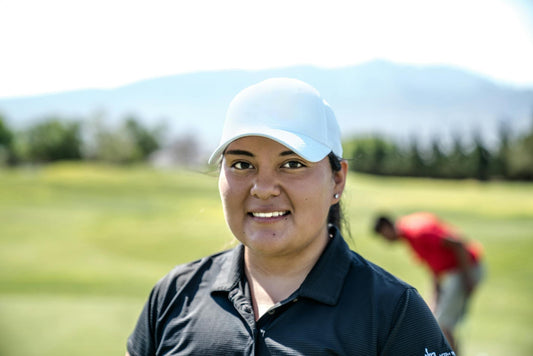 A woman golfer enjoys a sunny day on the golf course, showcasing her passion for the sport.